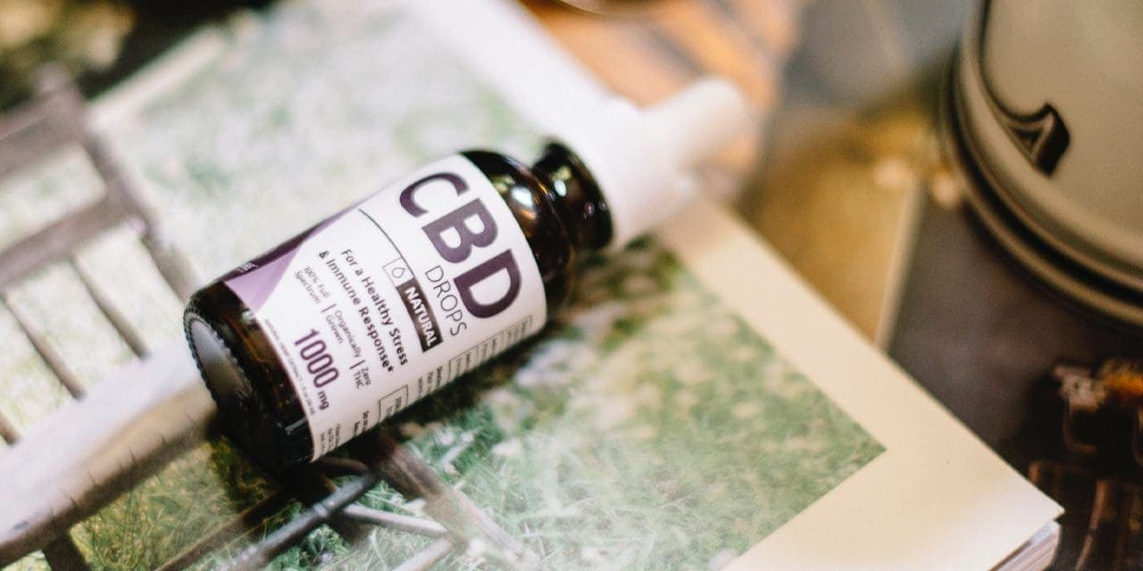 lying CBD drops bottle