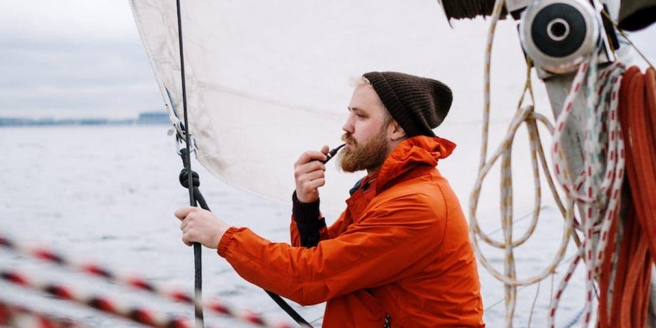 a man sailing with a boat while using a vape pen